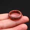 Polished natural agate ring with dark reddish-brown stone texture shown on finger - Sesame Jasper