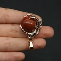 Gothic gold-plated dragon claw pendant holding a sparkling brown goldstone sphere - Gold Sandstone