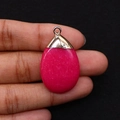 Detailed close-up of a rose red teardrop stone pendant with a gold clasp held in hand - Rose Red Stone (Gold Cap) / Rose Red