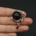 Golden dragon claw pendant featuring a black and white snowflake stone orb accessory - Black Line Howlite