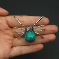 Silver spider pendant with green spotted stone held in hand for size comparison - 34x47mm, 14g / Turquoise
