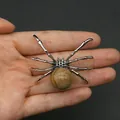 Silver spider pendant with natural brown marbled stone inlay held in hand - 34x47mm, 14g / Jasper