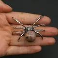 Silver spider pendant with pink speckled natural stone inlay held in hand - 34x47mm, 14g / Rhodonite
