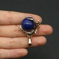 Golden dragon claw pendant holding a deep blue spherical gemstone bead for necklace - Enhanced Lapis Lazuli