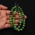 Close-up of green natural stone beads with black spots for DIY jewelry making - Green with Black Spots