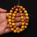 Detail of colorful imperial stone beads in vibrant orange and yellow for DIY jewelry - Orange Yellow Earth Red Mottled (No. 25)