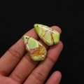 Detailed close-up of water drop shaped imperial stone pendants with natural texture - No.3 (Green Yellow Red Veins)