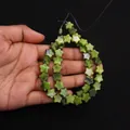 Star-shaped natural green emperor stone beads held in palm for DIY jewelry making - 10x10mm (4mm Thickness) / Grass Green (No. 7)