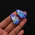 Detailed view of teardrop purple turquoise pendants held by hand for DIY jewelry making - No.4 (Purple Blue Marble)