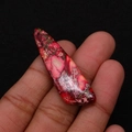 Macro detail of red imperial stone pendant with natural marble textures and polished finish - 13x45mm / Red/Pink/Gray-White Marble