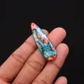 Macro shot of teardrop shaped blue and orange emperor stone pendant held by hand - Blue Red Orange Spliced Polished Style (No. 15)