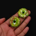 Macro shot of two green emperor stone donut pendants showing natural mineral textures - Style 2 (Grass Green Marble) / 30mm