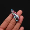 Hand holding a colorful teardrop-shaped natural stone pendant with a unique mosaic pattern - Blue Purple Red Brown Artistic Style (No. 10)