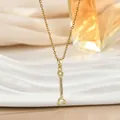 Macro shot of a golden wrench pendant necklace featuring sparkling cubic zirconia stones - Gold Wrench Style (XL02465)