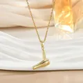 Detailed close-up of a golden mini hair dryer pendant on a delicate chain with silk texture - Hairdryer Style (XL02467)