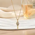 Detalle de cerca de un collar con colgante de globo aerostático 3D y pavé de piedras - Estilo Globo Aerostático Oro Pavé (XL02457)