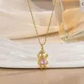 Makroansicht von Gold-Astronaut-Anhänger mit rosa Edelstein und feiner Gliederkette - Astronaut Stil (XL02539)