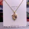 Detail view of a gold dolphin projection necklace featuring white zircons on a display card - Dolphin Shape (TY0037) / Gold