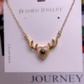 Macro shot of gold reindeer heart necklace with crystal stones and projection stone - Antler Heart Shape (TY0038) / Gold