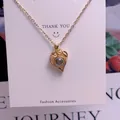 Detail of gold heart pendant necklace with projection stone on white display card - Pave Heart Style (TY0043) / Gold