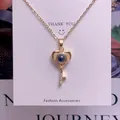 Detail shot of heart key pendant featuring micro-projection stone and zircon accents - Heart Key Shape (TY0044) / Gold