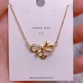 Titanium steel gold necklace featuring a bow and bee pendant with sparkling cubic zirconia - Bowknot Bee Infinity Style (SQ007)