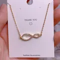 Close-up of gold infinity pendant with pavé cubic zirconia on titanium steel chain - Luxury Pave Infinity Style (SQ008)