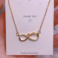 Detailed close-up of a gold infinity necklace with Berica lettering on display card - Letter Berica Infinity Style (SQ0011)