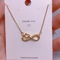 Macro shot of gold infinity heart pendant necklace with shimmering cubic zirconia - Love Heart Infinity Style (SQ0012)