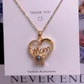 Macro detail of gold heart Mom necklace with 100 languages projection stone and pavé accents - Mom Heart Style (TY0060) / Gold