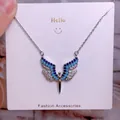 Macro shot of wing heart pendant necklace with blue and white sparkling crystals - Light Blue Dark Blue White Rhinestone Wings Style (CB01)