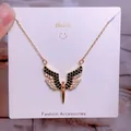 Detail of gold titanium steel necklace featuring a heart-shaped wings pendant with pave zircons - Gold Black White Two Tone Rhinestone Wings Style (CB02)
