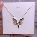 Golden titanium steel necklace featuring a winged heart pendant with blue crystals - Gold Multicolor Rhinestone Inlaid Wings Style (CB03)