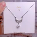 Collier clavicule argenté avec ailes en strass et détail de perle blanche élégante - Style Ailes Strass Argent Perle Artificielle (CB11)