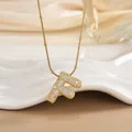 Detail of 18K gold plated letter F pendant with micro-paved sparkling cubic zirconia stones - Letter F