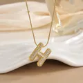 Detail of 18K gold plated letter H pendant necklace with sparkling micro-pave zircons - Letter H