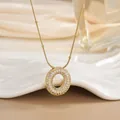 Macro detail of gold-plated pendant necklace with micro-paved cubic zirconia stones - Letter O