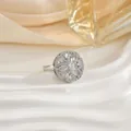 Elegant rotating floral ring with marquise-cut zircons displayed on a textured white plate - Snowflake Geometric Style (67)