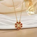 Elegant gold clover necklace with red heart petals on white ceramic jewelry tray - Red Enamel Gold (XL0548)
