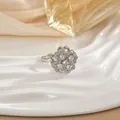 Macro detail of a silver floral spinning ring featuring micro-pave cubic zirconia on petals - Hollow Five-petal Flower Style (72)