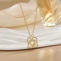 Elegant gold clover necklace with sparkling cubic zirconia on white marble base - Round Intertwined Gold (XL0557)
