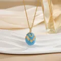 Macro detail of sky blue enamel egg pendant with gold wave patterns and zircon stones - Sky Blue Wavy Rhinestone Style (XL0652)