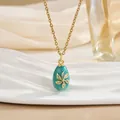 Detail of vintage egg pendant necklace with green enamel, gold floral patterns and zircons - Lake Green Gold Flower Style (XL0659)