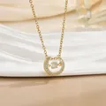 Detail of horseshoe pendant necklace with pavé stones and a floating center diamond - Horse Hoof Style (灵动系列37) / Gold