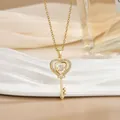Detail shot of a golden heart key pendant featuring sparkling zircon micro-pave setting - Hollow Heart Style (灵动系列50) / Gold
