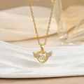 Detailed close-up of a gold heart necklace with sparkling wings on a luxury display - Winged Heart Style (灵动系列52) / Gold
