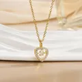 Macro shot of gold heart necklace featuring a dancing stone and pavé setting - Suspended Heart Style (灵动系列56) / Gold