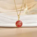 Close-up of gold chain necklace with red enamel FE letter charm and heart detail - Gold Round Red Enamel Letter Heart (XL1104A)