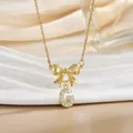Macro shot of gold bow necklace with letter G pendant encrusted in zircon stones - Letter G