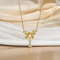 Detailed macro view of gold-plated necklace with sparkling bow and zircon letter I pendant - Letter I